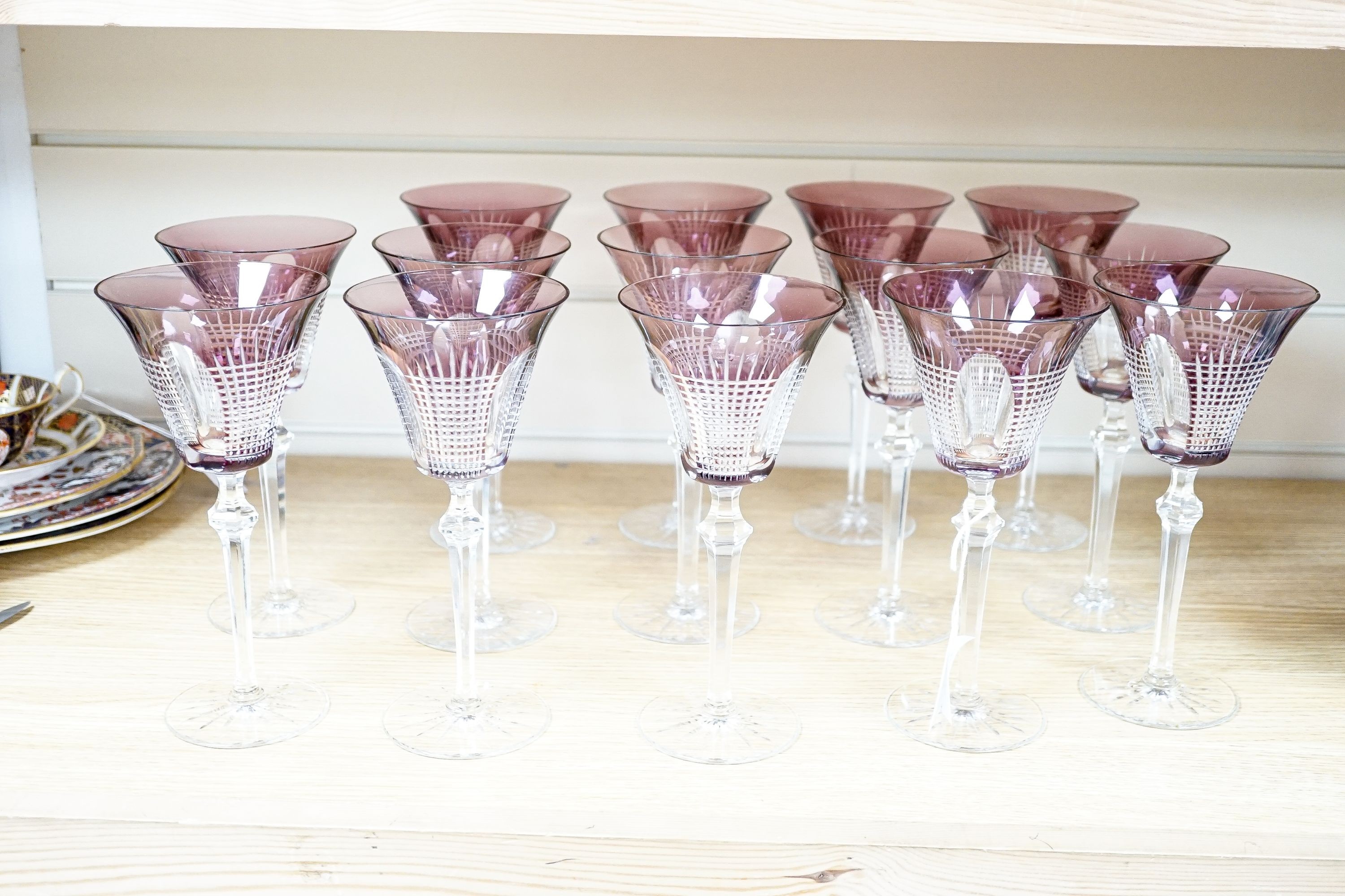 A set of fourteen cut amethyst flashed wine glasses, 21cm